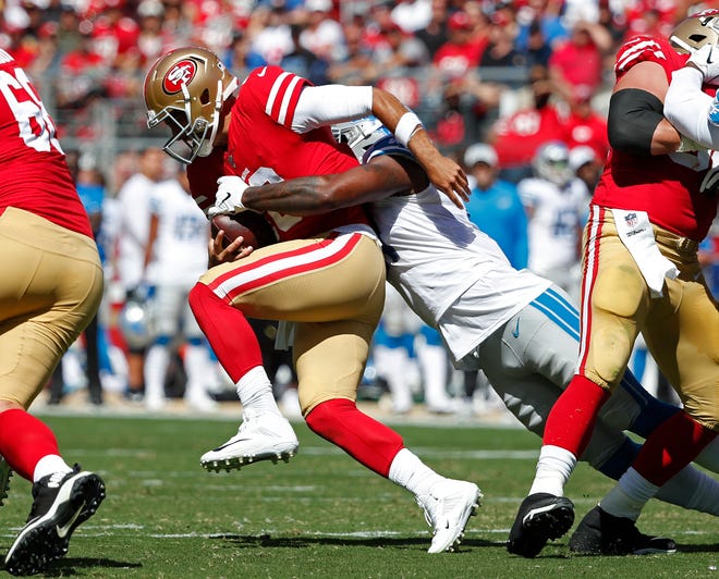 San Francisco 49ers quarterback Jimmy Garoppolo is sacked by the Detroit Lions' Eli Harold during the first half.