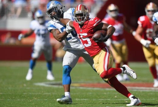 The 49ers' Pierre Garcon fights off the tackle of the Lions' Quandre Diggs during the fourth quarter.