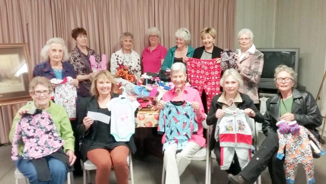 Ruidoso Woman's Club members show some of the pajama donations already received for the Nest domestic violence shelter.