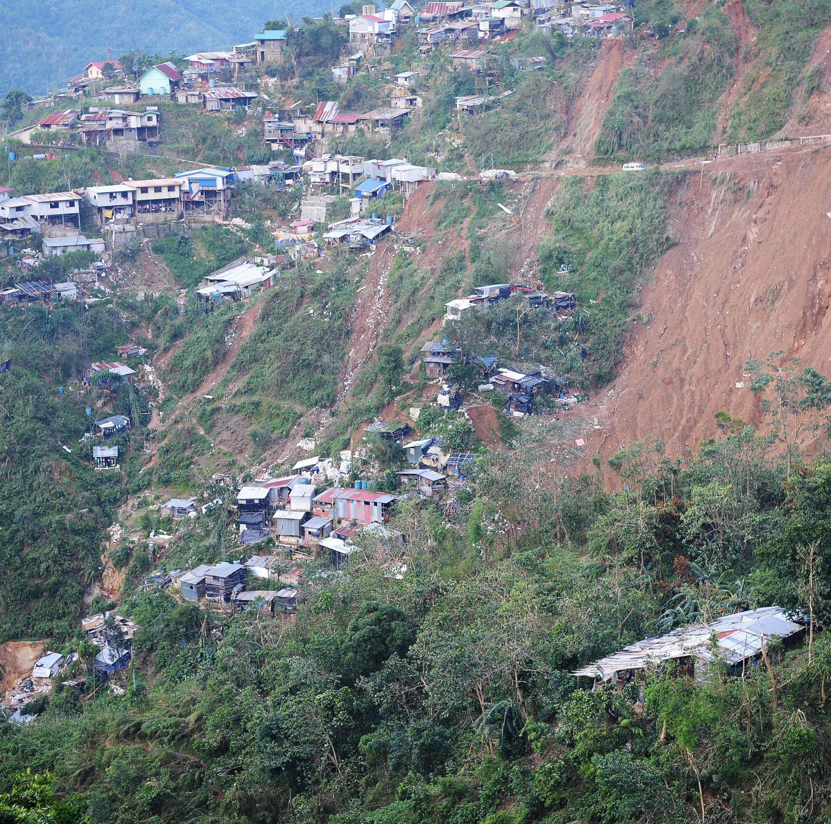 A general view shows the landslide site due to heavy rains brought by Typhoon Mangkhut in Itogon, Benguet province on September 17. Philippine rescuers used shovels and their bare hands to claw through mounds of rocky soil, as they desperately looked