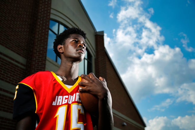 Shroder High School senior Muhammad Bah watches over practice as he poses for a portrait at Shroder High School in Cincinnati on Tuesday, Sept. 18, 2018. The senior kicker will miss the remainder of his senior season after breaking his collarbone on a special teams play.
