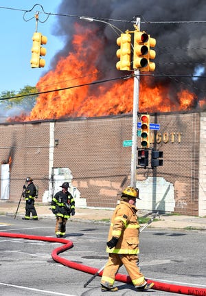Firefighters work a blaze at a commercial building on Puritan at Linwood in Detroit on Tuesday.