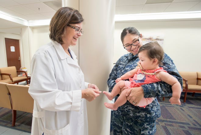 At left, Capt. Evelyn Quattrone, a nurse and midwife, chats Tuesday with Navy Corpsman Andrea Mendez and her baby, Maddison Armenta, at the new Comprehensive Women's Health Center at Pensacola Naval Hospital.