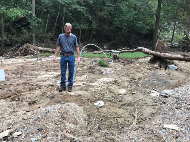 Donnie Grove stands in the patch of ground where his home once stood. "This was a beautiful place. It's not beautiful now," he said. Downstream, he found pieces of his house scattered for four miles.