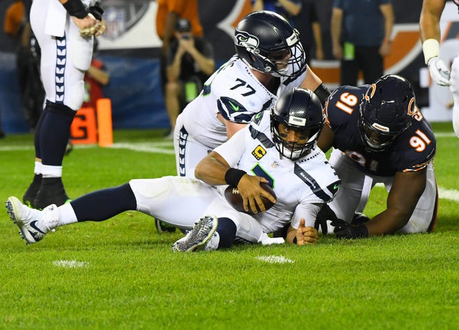 Seattle Seahawks quarterback Russell Wilson (3) is sacked by Chicago Bears defensive tackle Eddie Goldman (91) during the second quarter at Soldier Field.