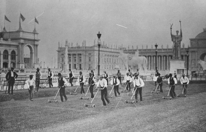 Men give a choreographed demonstration of Elwood McGuire's lawn mower in 1893 during the Columbian Exposition in Chicago.