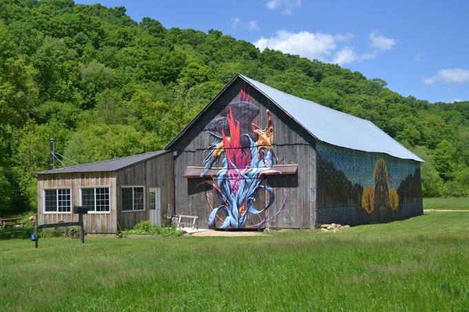 A venerable tobacco barn, seen here before the flood that destroyed it, was painted by a noted artist and was used for gatherings of up to 4,000 people each fall who came for wagon rides, pumpkin harvest and cookouts. The summer kitchen and wood-fired pizza oven were lost in the flood along with tractors and wagons.