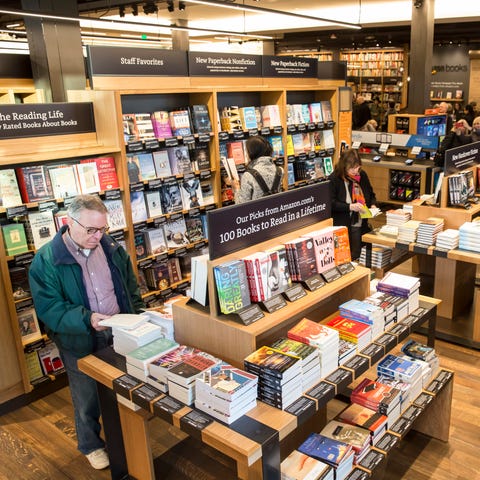 Customers browse books at Amazon Books store on No