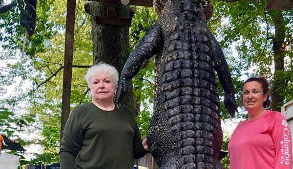 Judy Cochran, left, harvested a 12-foot,...
