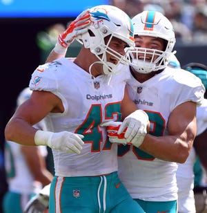 Miami Dolphins linebacker Kiko Alonso (47) celebrates forcing a fumble with Miami Dolphins linebacker Chase Allen (59) in the first half  against the New York Jets at MetLife Stadium.