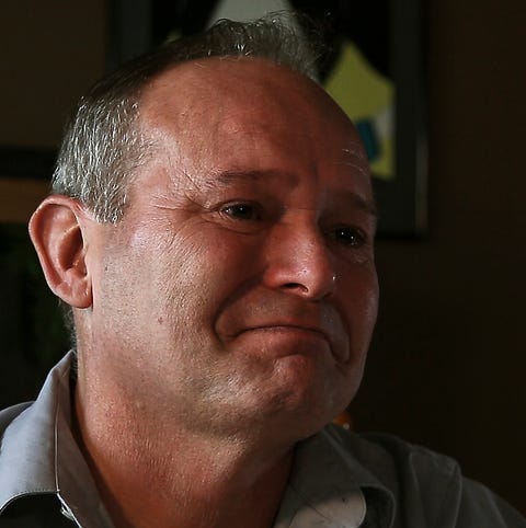 Jeff Dettbarn tries to hold back tears during an...