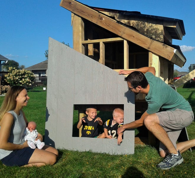 This new urban chicken coop under construction in the Fox Run area of North Liberty is a family project of the Carne family.  From left are Kristi holding Hazel, Cade, Archer and Clint.