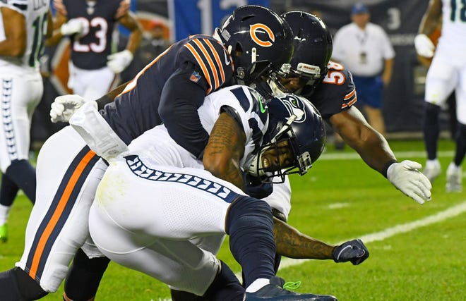 Seahawks receiver Brandon Marshall (15) is tackled by Bears linebacker Khalil Mack (52) during the second quarter of a game Monday at Soldier Field.