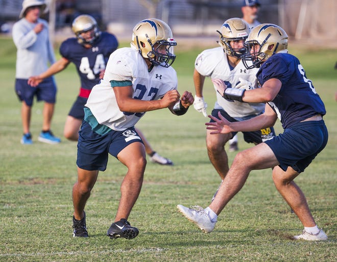 Tyson Grubbs , left, is the main running back for Desert Vista High School and has led the team to a 4-0 start.