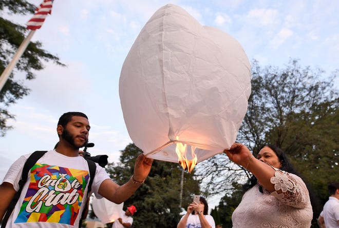 Raul Miranda, left, and Olga Davis launch a lantern over Kiwanis Lake in memory of Erik Miranda, Thursday, Sept. 20, 2018. Miranda was murdered Sept. 20, 2015, in a drive-by shooting. His case is one of only a few cold cases in York City. John A. Pavoncello photo