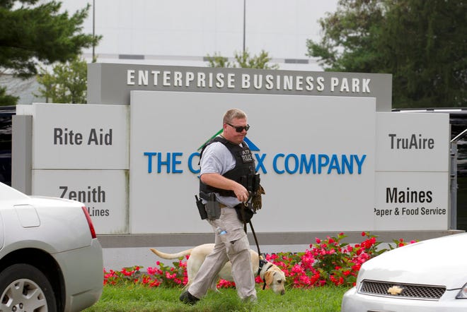 ATF police officer with a sniffing dog walks out the industrial complex in Harford County, Md., Thursday, Sept. 20, 2018. Authorities say multiple people have been shot in northeast Maryland in what the FBI is describing as an "active shooter situation." (AP Photo/Jose Luis Magana)