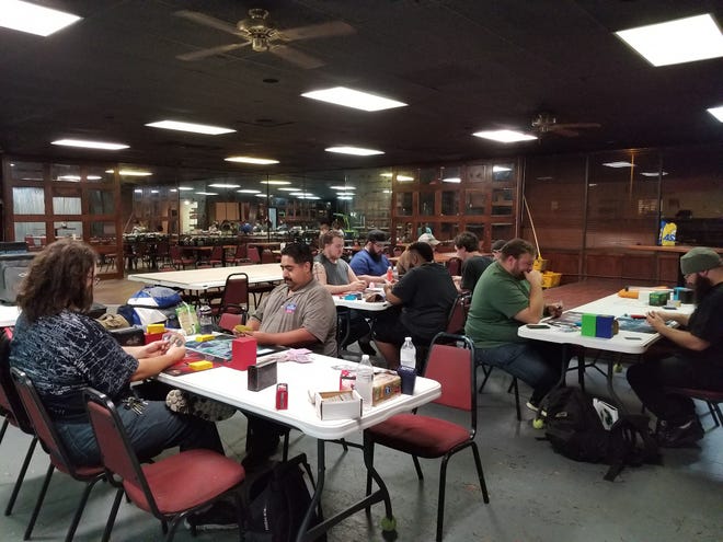 People playing Magic the Gathering and Yu-Gi-Oh at Phat Catz Gaming, 2019 N Bryant Blvd.