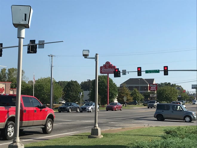Cars waiting for a traffic signal to change under the watch of the red-light cameras at Wilma Rudolph Boulevard and Trenton Road.