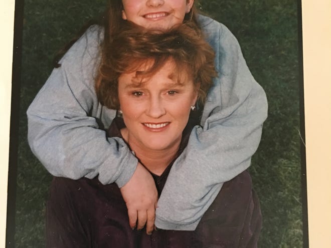 CJ Macon and her mother Kim Macon pose for a family photo in the mid 1990's.