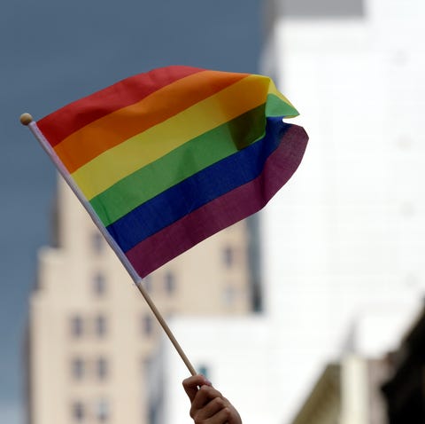 A participant waves a rainbow flag during the annu
