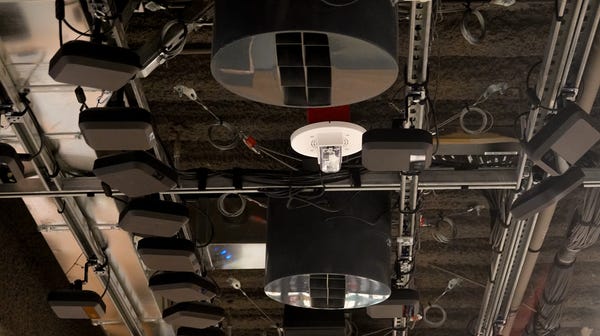 A wall of cameras and sensors on the ceiling of...