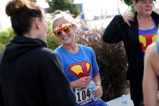 Jessica Cash, 35, of New Hudson talks with a group of friends who ran to support her in the 2018 Detroit Undy RunWalk on the Detroit Riverwalk on Saturday, Sept. 22, 2018. Cash was diagnosed with rectal cancer in 2015. 
