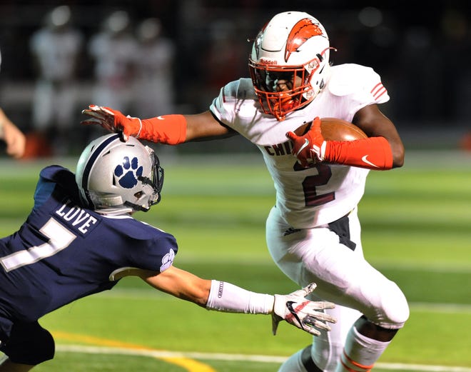 Clinton Township Chippewa Valley running back Ja'Von Kimpson, right, rushes past Macomb Dakota defensive back Matt Love for a touchdown in the fourth quarter on Friday.