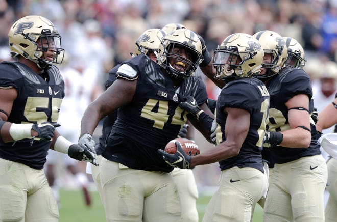 Purdue defensive tackle Anthony Watts (44) celebrates an interception with linebacker Max Richardson (14) during the second half on Saturday.