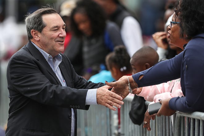 Sen. Joe Donnelly greets spectators at the Circle City Classic Parade in downtown Indianapolis, Saturday, Sept. 22, 2018.