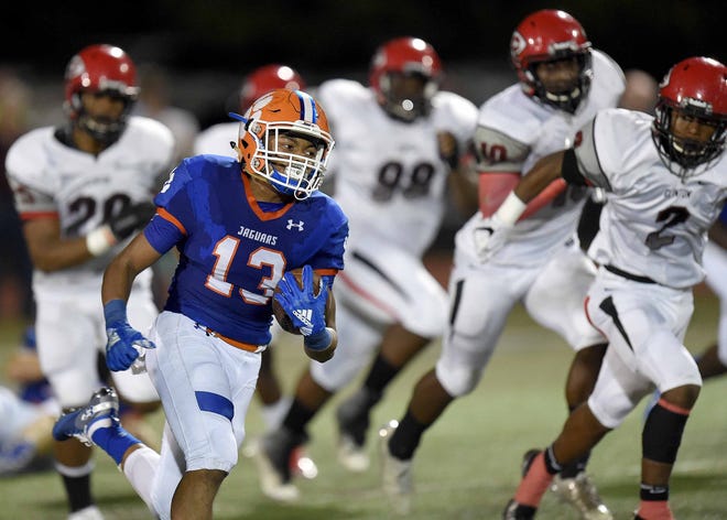 Madison Central's Duke Arnold (13) breaks into the secondary against Clinton on Friday, September 21, 2018, at Madison Central High School in Madison, Miss.