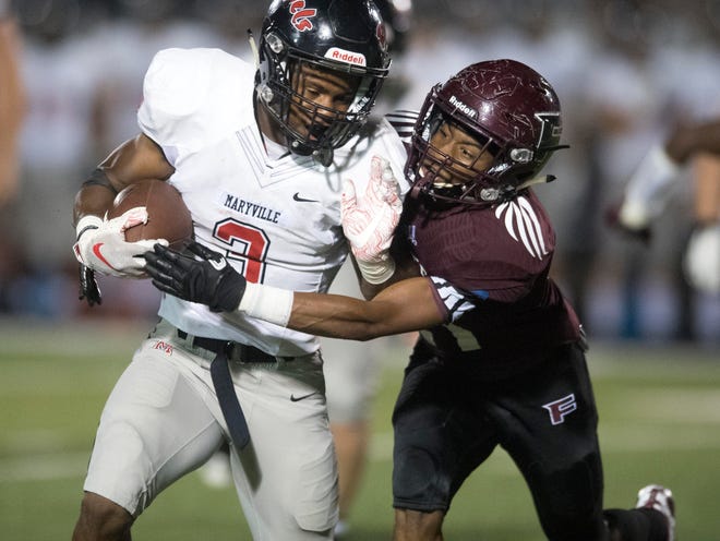 Maryville's A.J. Davis (3) is tackled by Fulton's Kevin Johnson (21) in the football at Fulton on Friday, September 21, 2018.
