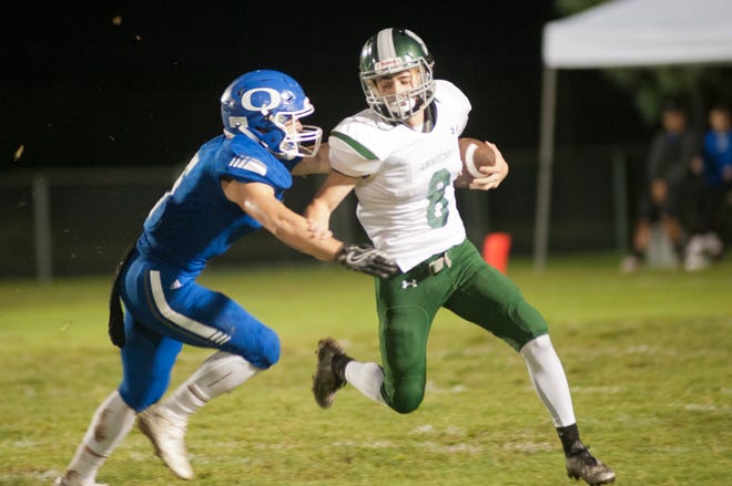 Oldham County linebacker Preston Dykes closes in on South Oldham quarterback Anthony Pierce as Oldham County hosts South Oldham in the cross-county high school football rivalry.September 21, 2018