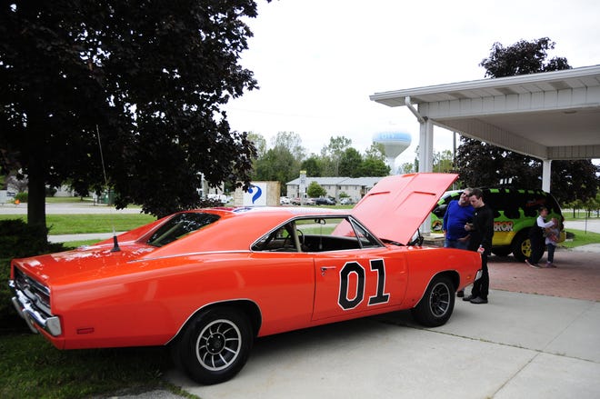 Brian and Colin Sterling of Ira Township admire a version of the General Lee from The Dukes of Hazzard at the International Marine City Comic  Con at the RIvertown Event Centre in Marine City.
