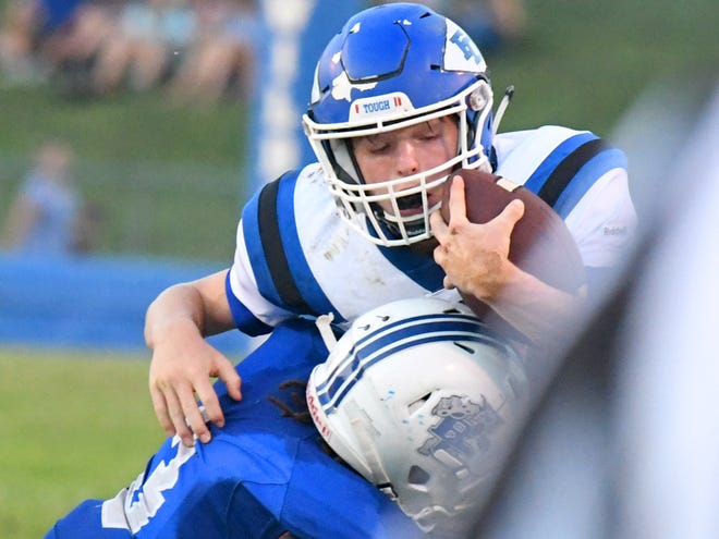 Fort Defiance's Cole Sligh braces himself with the ball as Rockbridge County's Elijah Poindexter shoves him out of bounds during a football game played in Lexington on Friday, Sept. 21, 2018.