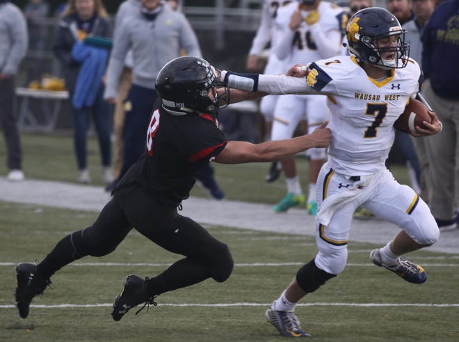 Photos by Corey SchjothWausau West player Mitchell Zahurones, right, takes the ball past SPASH Player Desmond Schommer during the SPASH Wausau West game in Stevens Point Friday night.