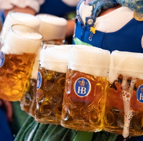 A waitress carries mugs of beer during the opening