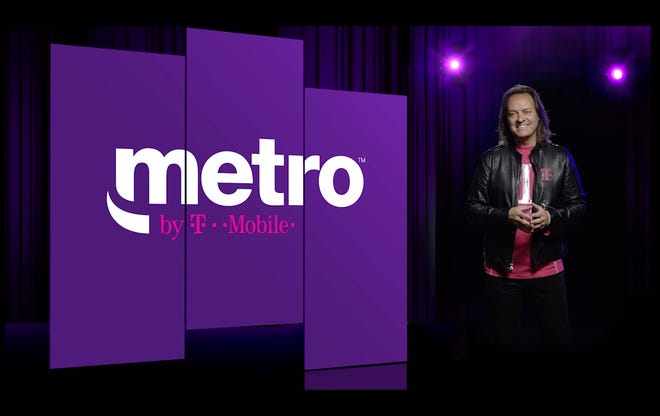 T-Mobile CEO John Legere poses next to new Metro by T-Mobile logo. MetroPCS ditches PCS in a name change.