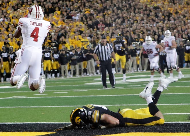 Wisconsin wide receiver A.J. Taylor catches the game-winning touchdown catch while being covered bay Iowa linebacker Nick Niemann.