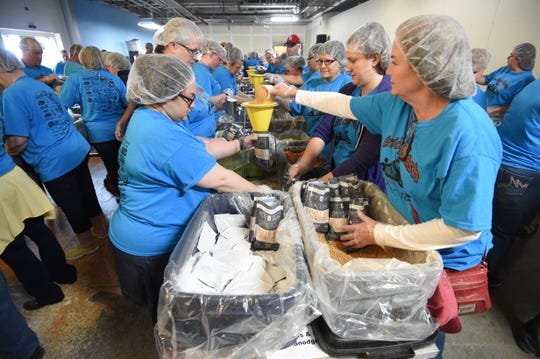 Volunteers work on packaging meals at last year's Bridge Bash. The event returns Saturday to the campus of Arkansas State University-Mountain Home with the goal of packaging 100,000 meals and raising enough donations to purchase another 500,000.