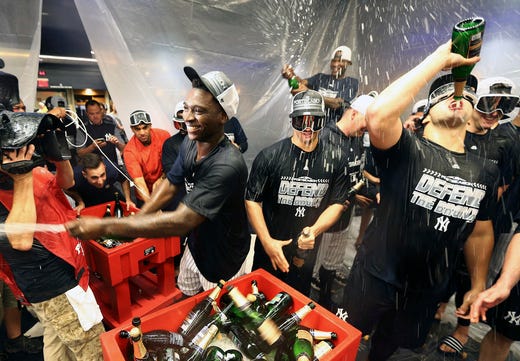 The New York Yankees celebrate in the locker room after defeating the Baltimore Orioles at Yankee Stadium. Mandatory Credit: Andy Marlin-USA TODAY Sports