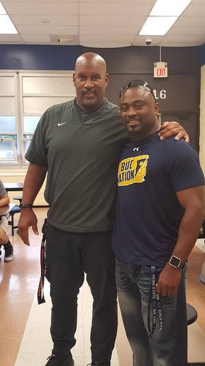 David Grant (left) a former BHS football player who later competed in Super Bowl XXIII for the Cincinnati Bengals, with coach Jermain Johnson.