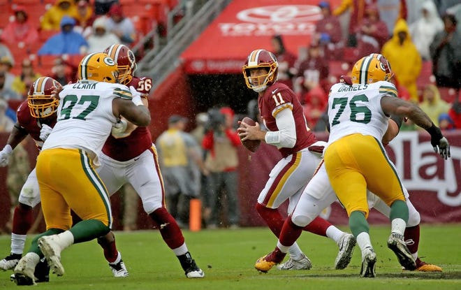 Green Bay Packers nose tackle Kenny Clark (97) and defensive tackle Mike Daniels (76) try to rush quarterback Alex Smith (11) against Washington Sunday, September 23, 2018 at FedEx Field in Landover, MD.
