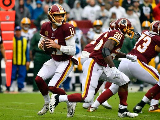 Sep 23, 2018; Landover, MD, USA; Washington Redskins quarterback Alex Smith (11) drops back to pass against the Green Bay Packers during the first quarter at FedEx Field. Mandatory Credit: Brad Mills-USA TODAY Sports