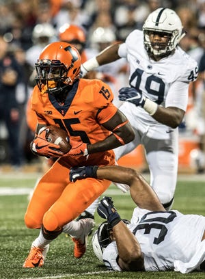 Illinois wide receiver Trenard Davis (15) is tackled by Penn State's Kevin Givens (30) during the second half of an NCAA college football game Friday, Sept. 21, 2018, in Champaign, Ill. (AP Photo/Holly Hart)