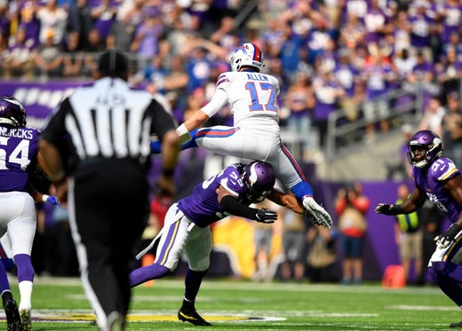 Josh Allen #17 of the Buffalo Bills hurdles Anthony Barr #55 of the Minnesota Vikings while carrying the ball in the first half of the game at U.S. Bank Stadium on September 23, 2018 in Minneapolis, Minnesota.
