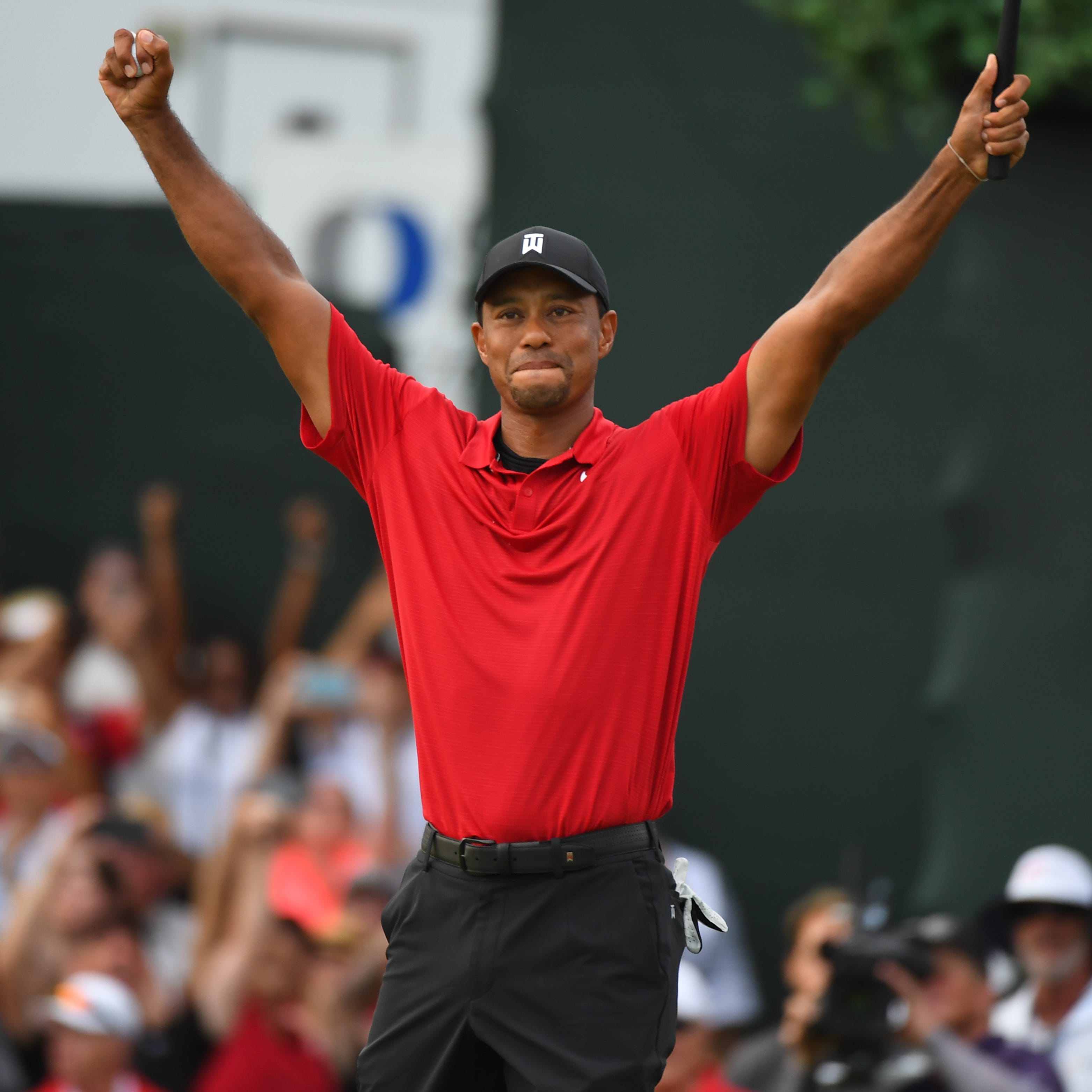 Tiger Woods reacts to winning the Tour Championship golf tournament at East Lake Golf Club.