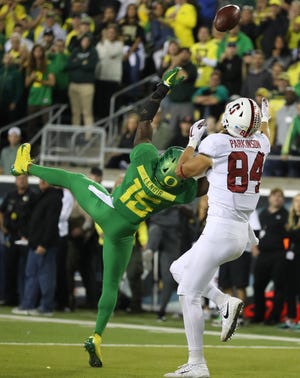 Stanford Cardinal tight end Colby Parkinson (84) tips the ball to himself for a touchdown over Oregon Ducks cornerback Deommodore Lenoir (15) in overtime at Autzen Stadium.