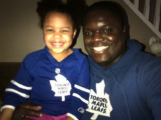 Mike Labinjo, pictured here with his 10-year-old daughter, Hailey, died Saturday morning in his sleep. He was 38.