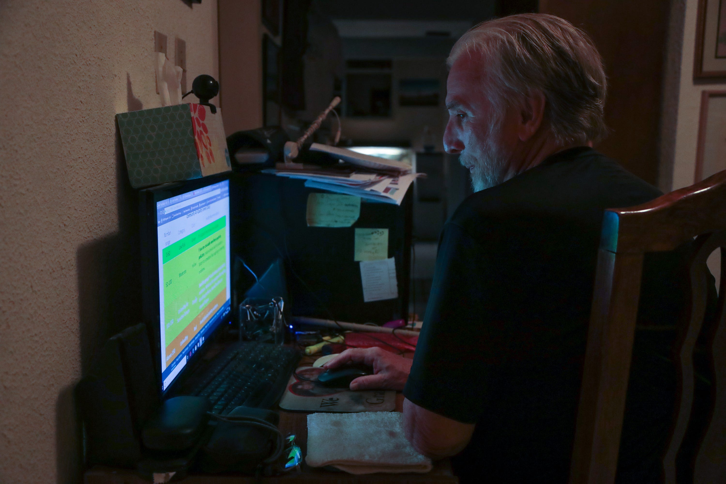 Ray Askins, an environmental activist, checks the readings of an air monitor at his home in Mexicali on Sept. 19, 2018. The monitor is installed on his roof.