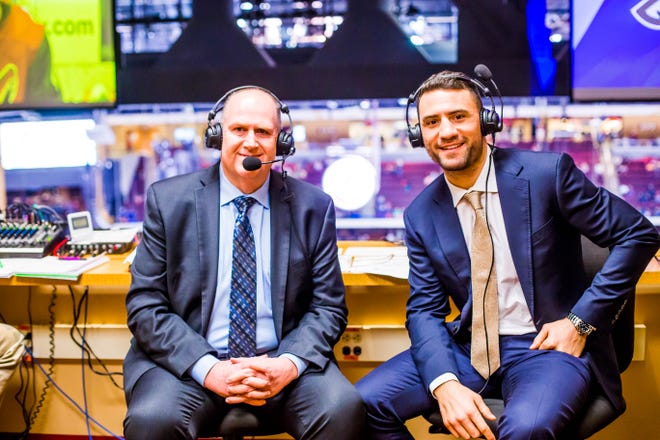 Coyotes radio analyst Paul Bissonnette (right) poses with play-by-play announcer Bob Heethuis (left) before a 2017-18 regular-season game.
